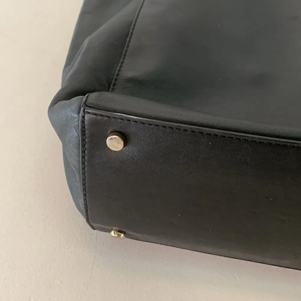 Kate Spade black leather tote bag with exterior and interior pockets